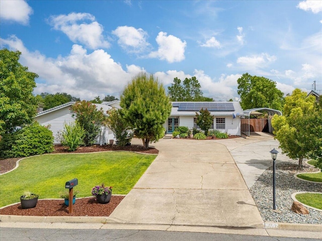 7597 Terra Linda Way, Redding, CA 96003 - view of front of property featuring concrete driveway, solar panels, and a carport