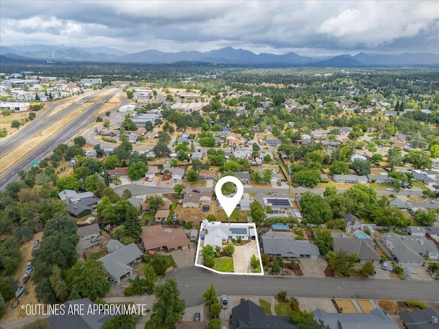 7597 Terra Linda Way, Redding, CA 96003 - aerial view of property and surrounding area with a mountain backdrop, nearby suburban area, and property boundaries highlighted