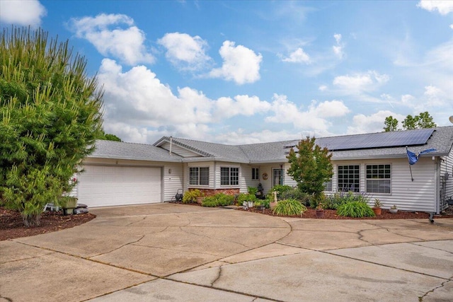 7597 Terra Linda Way, Redding, CA 96003 - ranch-style house featuring an attached garage, driveway, and roof mounted solar panels