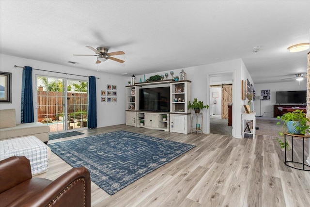 7597 Terra Linda Way, Redding, CA 96003 - living area featuring ceiling fan, a barn door, and wood finished floors