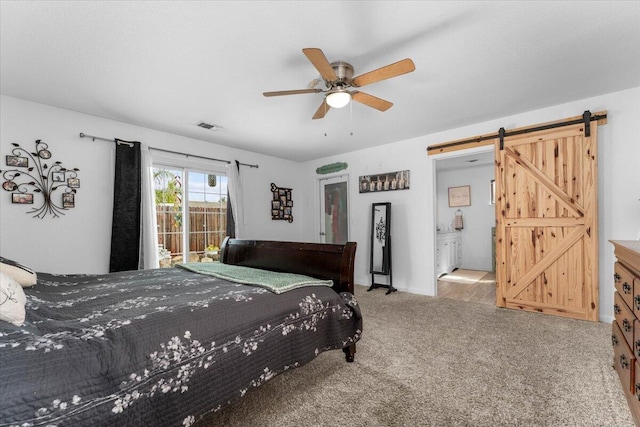7597 Terra Linda Way, Redding, CA 96003 - carpeted bedroom featuring a barn door, ceiling fan, baseboards, and ensuite bathroom