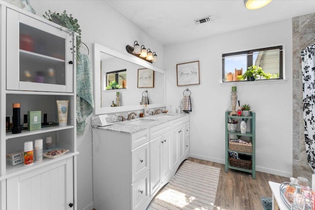 7597 Terra Linda Way, Redding, CA 96003 - full bath featuring wood finished floors, double vanity, and baseboards