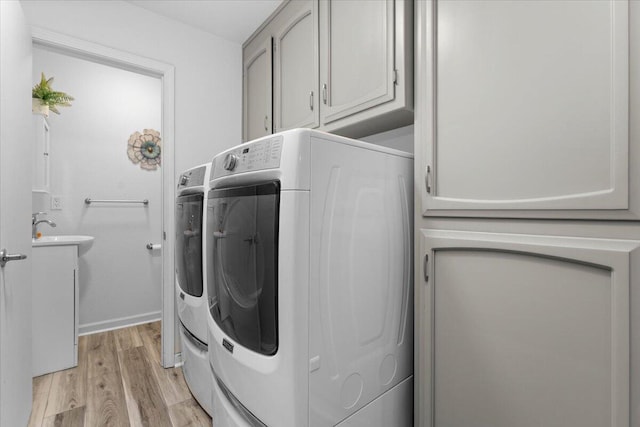7597 Terra Linda Way, Redding, CA 96003 - laundry area with cabinet space, light wood finished floors, independent washer and dryer, and baseboards