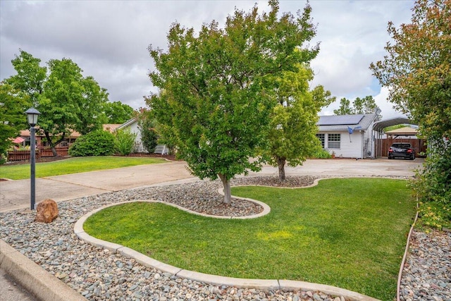 7597 Terra Linda Way, Redding, CA 96003 - obstructed view of property featuring a front yard, solar panels, a detached carport, and driveway