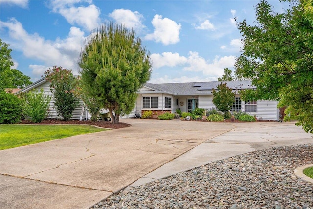 7597 Terra Linda Way, Redding, CA 96003 - ranch-style house featuring roof mounted solar panels and driveway