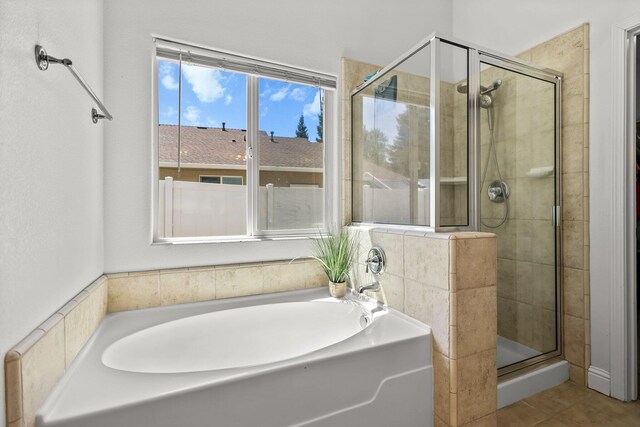 406 Spire Point Dr, Redding, CA 96003 - bathroom with a shower stall, a bath, and tile patterned floors