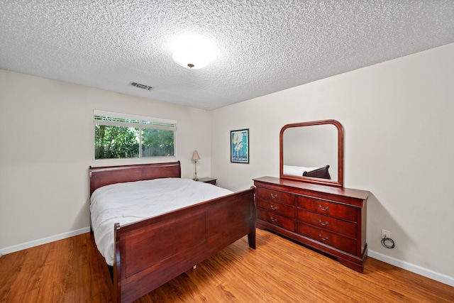 1836 Del Mar Ave, Redding, CA 96003 - bedroom with light wood-type flooring and a textured ceiling