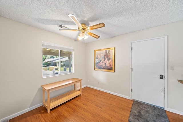 1836 Del Mar Ave, Redding, CA 96003 - foyer entrance with light wood finished floors, ceiling fan, and a textured ceiling