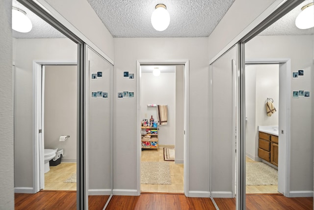 1836 Del Mar Ave, Redding, CA 96003 - hall featuring wood finished floors and a textured ceiling