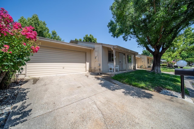1836 Del Mar Ave, Redding, CA 96003 - view of front facade with a garage, driveway, stucco siding, a front lawn, and covered porch