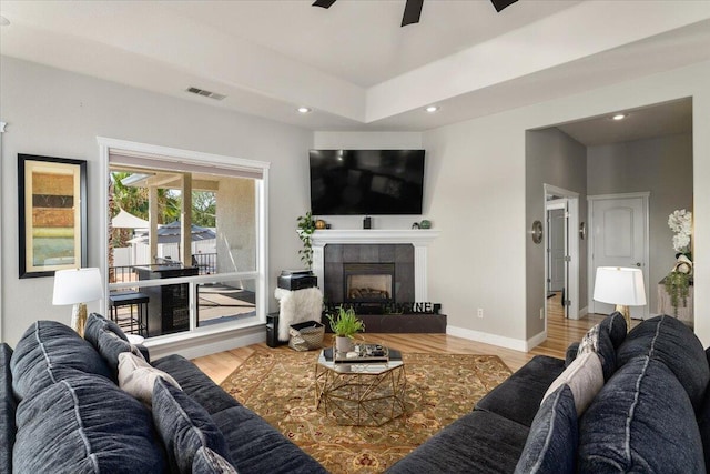 1235 Chandon Ct, Redding, CA 96003 - living area with ceiling fan, a tile fireplace, wood finished floors, recessed lighting, and baseboards