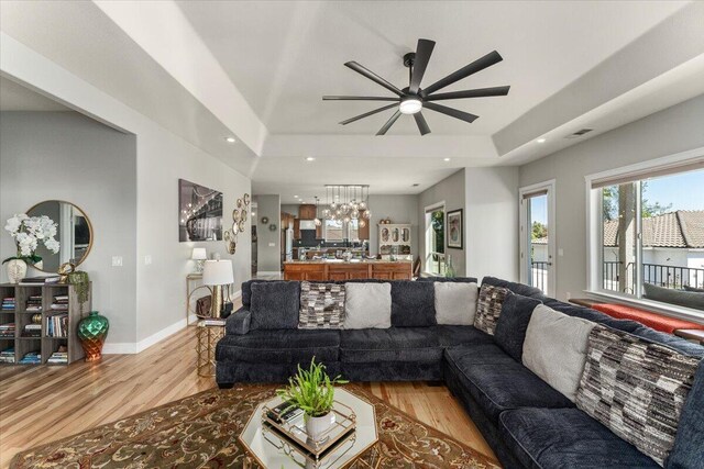 1235 Chandon Ct, Redding, CA 96003 - living area featuring a tray ceiling, light wood-style floors, ceiling fan, recessed lighting, and baseboards