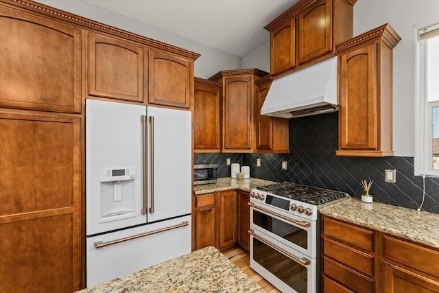 1235 Chandon Ct, Redding, CA 96003 - kitchen with white appliances, premium range hood, light stone countertops, and tasteful backsplash