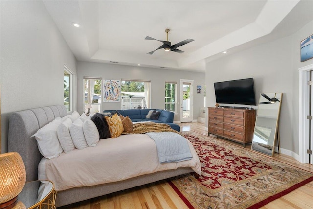 1235 Chandon Ct, Redding, CA 96003 - bedroom featuring a tray ceiling, wood finished floors, access to outside, ceiling fan, and recessed lighting