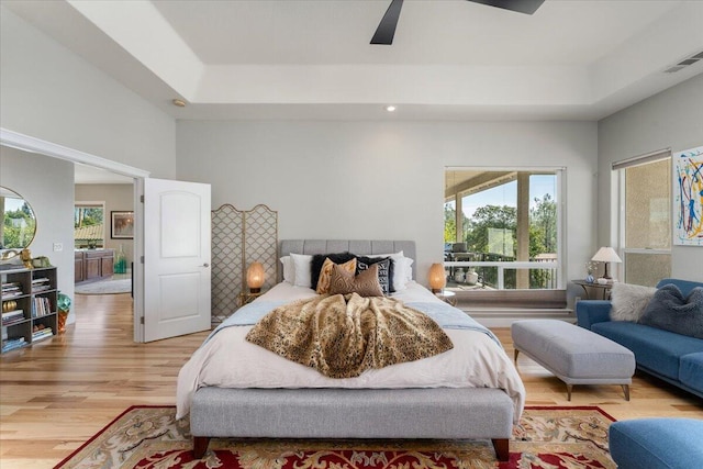 1235 Chandon Ct, Redding, CA 96003 - bedroom featuring light wood-style floors, a ceiling fan, a raised ceiling, and recessed lighting