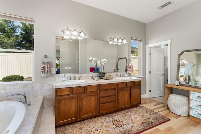 1235 Chandon Ct, Redding, CA 96003 - bathroom featuring a garden tub, wood finished floors, and double vanity