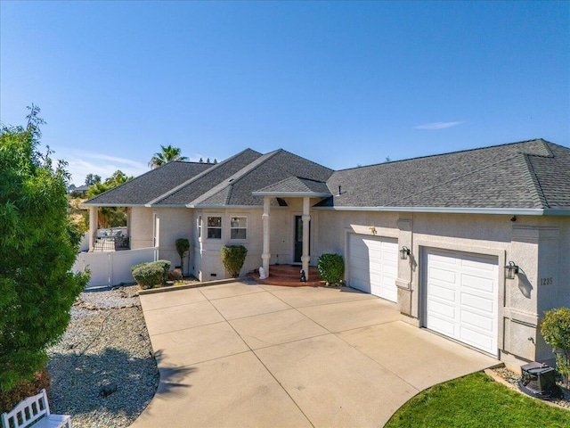 1235 Chandon Ct, Redding, CA 96003 - ranch-style house featuring an attached garage, concrete driveway, stucco siding, and a shingled roof
