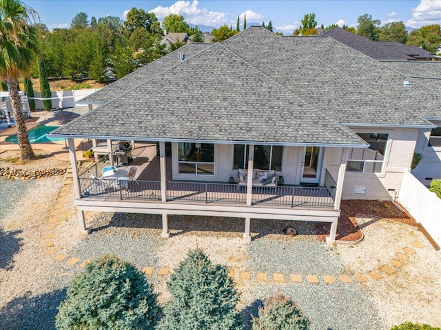 1235 Chandon Ct, Redding, CA 96003 - rear view of house with a shingled roof, a fenced backyard, a wooden deck, and stucco siding
