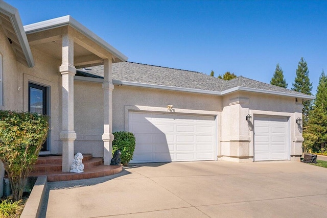 1235 Chandon Ct, Redding, CA 96003 - view of property exterior featuring stucco siding, a garage, and driveway