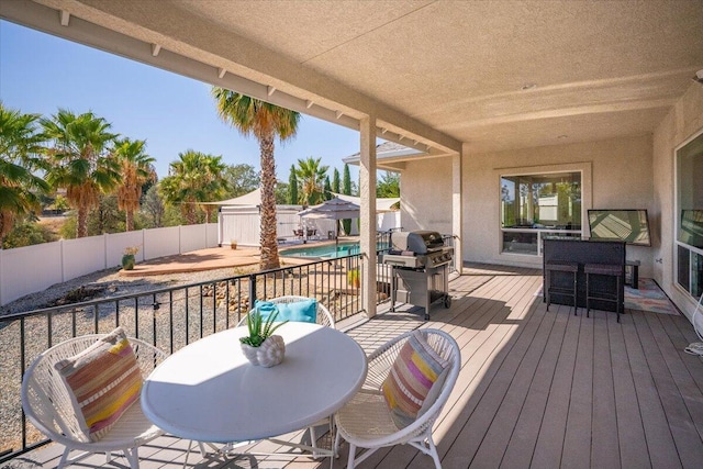 1235 Chandon Ct, Redding, CA 96003 - wooden deck with outdoor dining space, a fenced backyard, and a grill