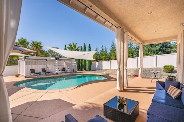1235 Chandon Ct, Redding, CA 96003 - view of swimming pool featuring a patio area, an outdoor living space, and a fenced backyard