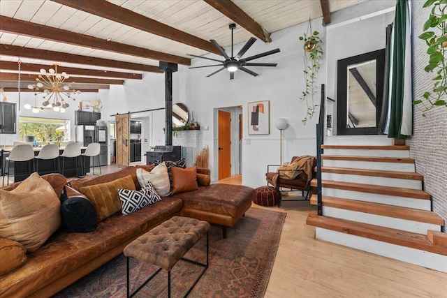19697 Old Indian Trl, Redding, CA 96003 - living room featuring a chandelier, wood finished floors, a wood stove, a ceiling fan, and beamed ceiling