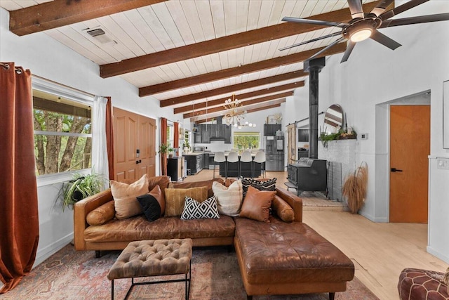 19697 Old Indian Trl, Redding, CA 96003 - living room featuring a wood stove, healthy amount of natural light, a ceiling fan, a chandelier, and wood ceiling