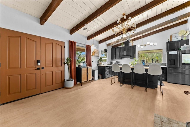 19697 Old Indian Trl, Redding, CA 96003 - kitchen featuring refrigerator with ice dispenser, light countertops, light wood-type flooring, a breakfast bar, and wood ceiling