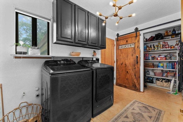 19697 Old Indian Trl, Redding, CA 96003 - washroom with cabinet space, a barn door, independent washer and dryer, light wood-type flooring, and a chandelier