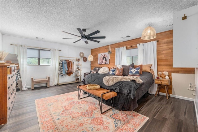 19697 Old Indian Trl, Redding, CA 96003 - bedroom featuring wooden walls, wood finished floors, baseboards, a textured ceiling, and ceiling fan