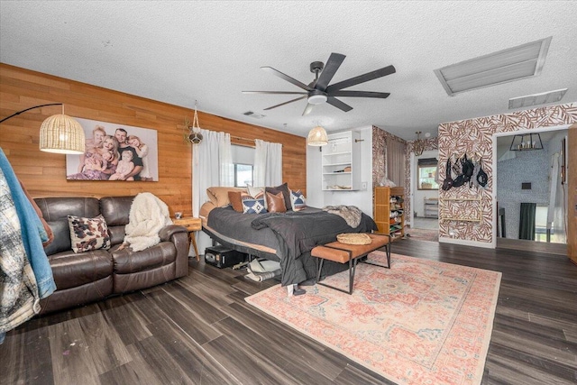 19697 Old Indian Trl, Redding, CA 96003 - bedroom featuring wood walls, wood finished floors, a textured ceiling, and ceiling fan
