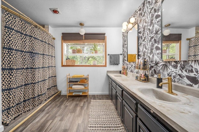 19697 Old Indian Trl, Redding, CA 96003 - full bathroom featuring wood finished floors, a textured ceiling, double vanity, and baseboards