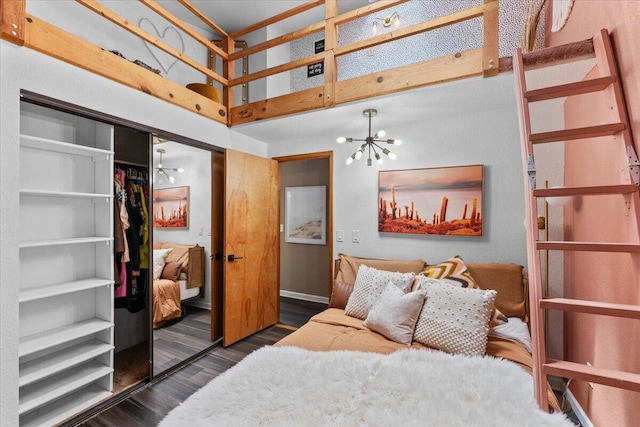 19697 Old Indian Trl, Redding, CA 96003 - bedroom with a chandelier, a towering ceiling, wood finished floors, a closet, and baseboards