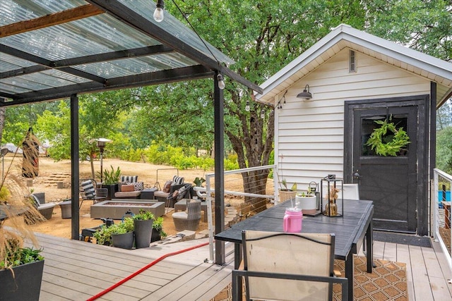 19697 Old Indian Trl, Redding, CA 96003 - wooden deck featuring outdoor dining area, outdoor lounge area, and an outdoor structure