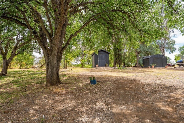 19697 Old Indian Trl, Redding, CA 96003 - view of yard featuring a storage unit and an outbuilding