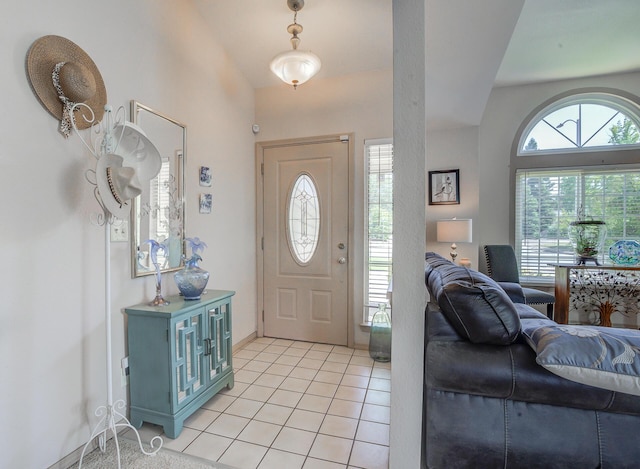 entrance foyer with light tile patterned floors and baseboards