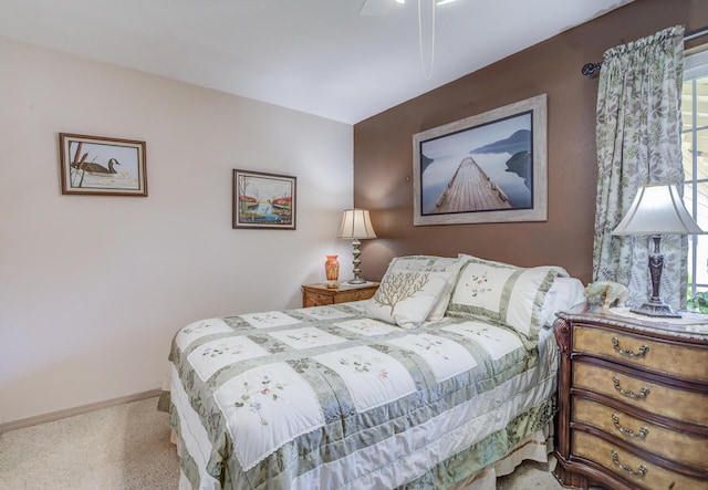 bedroom with carpet flooring, baseboards, and ceiling fan