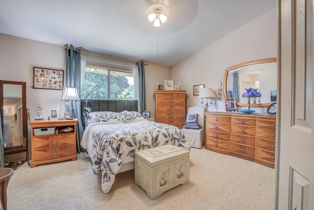 bedroom with light colored carpet, lofted ceiling, and ceiling fan