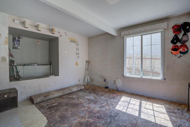 spare room featuring beamed ceiling