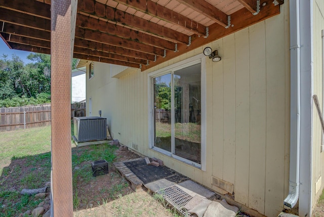 view of patio with cooling unit and fence