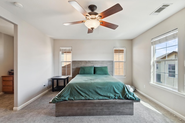 carpeted bedroom with baseboards and ceiling fan