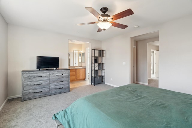 bedroom featuring light carpet, baseboards, connected bathroom, and ceiling fan