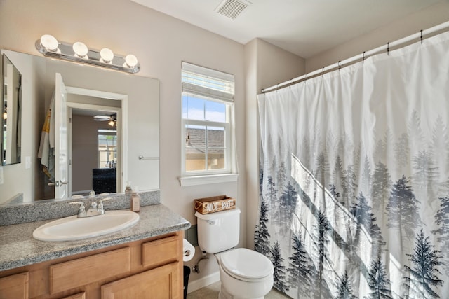 bathroom featuring vanity, toilet, and a shower with curtain