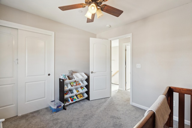 bedroom with carpet, a closet, and a ceiling fan