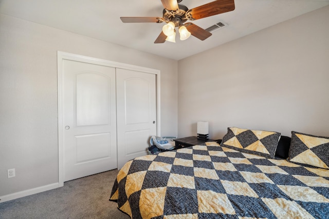 carpeted bedroom with a closet, ceiling fan, and baseboards