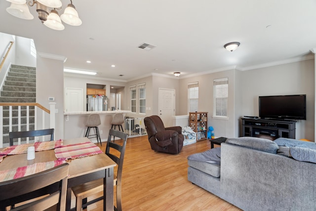 living room featuring light wood finished floors, stairway, ornamental molding, a chandelier, and recessed lighting