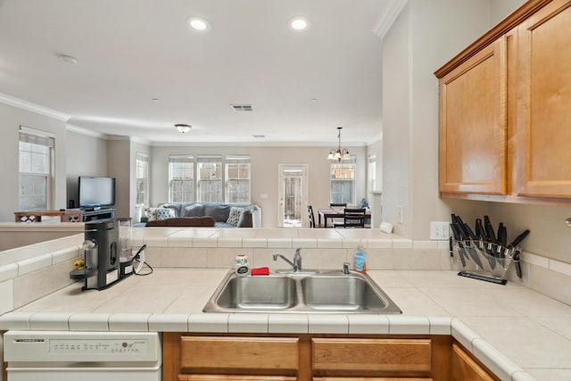 kitchen with open floor plan, white dishwasher, a sink, ornamental molding, and a chandelier