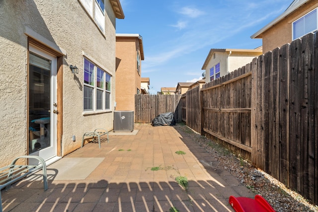 view of patio with cooling unit and a fenced backyard