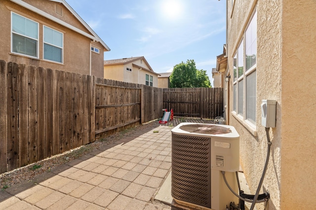 view of patio / terrace with central AC unit and a fenced backyard