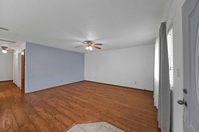 1945 Luning St, Red Bluff, CA 96080 - empty room with ceiling fan, wood finished floors, a textured ceiling, and baseboards